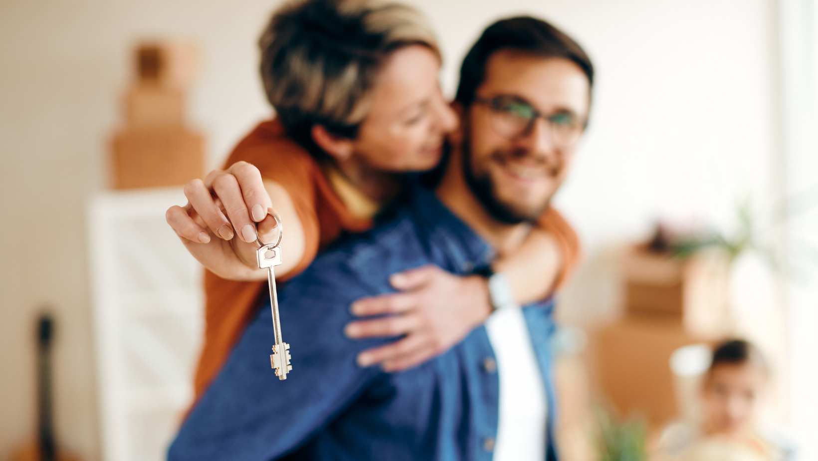 Two New Homeowners Embrace in their Dream Home with Sparkling Smiles